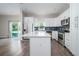Bright kitchen featuring stainless steel appliances, white cabinets, and eat-in island at 2314 Pennsylvania Ave, Oviedo, FL 32765