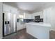 Modern kitchen boasts stainless steel appliances, white cabinetry, and a quartz countertop island at 2314 Pennsylvania Ave, Oviedo, FL 32765