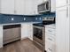 Updated kitchen with stainless steel appliances, white cabinets, and subway tile backsplash at 2314 Pennsylvania Ave, Oviedo, FL 32765
