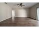Open-concept living room featuring wood floors, neutral walls, and a sliding door to the outdoor area at 2314 Pennsylvania Ave, Oviedo, FL 32765