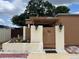 Charming front entrance with a decorative pergola, a gate, and a small garden adding curb appeal at 2487 Harbour Way, Winter Park, FL 32792