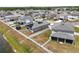 Aerial shot of a neighborhood featuring a fenced yard, solar panels, trampoline, and pond view at 2515 W End Dr, St Cloud, FL 34772
