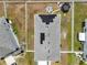 Aerial view of the home with a solar-paneled roof and spacious backyard with a firepit and trampoline at 2515 W End Dr, St Cloud, FL 34772