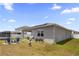 A spacious fenced backyard featuring a fire pit, covered patio, and well-maintained lawn at 2515 W End Dr, St Cloud, FL 34772
