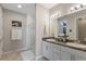 Bright bathroom featuring a double vanity with granite countertops and a glass-enclosed shower at 2515 W End Dr, St Cloud, FL 34772