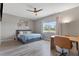 Bedroom features a comfortable bed, wall decorations, a desk, and a chair, complemented by natural light from a window at 2515 W End Dr, St Cloud, FL 34772