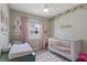 Sweet Bedroom features a crib, changing station, and soft pastel colors, creating a cozy and inviting space at 2515 W End Dr, St Cloud, FL 34772