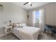 Bright bedroom featuring a comfortable bed, side tables, and a desk area, complemented by natural light from the window at 2515 W End Dr, St Cloud, FL 34772