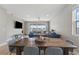 Dining area open to living room, featuring a wooden table with seating for six at 2515 W End Dr, St Cloud, FL 34772