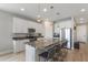 Bright kitchen with white cabinetry, granite counters, and stainless steel appliances at 2515 W End Dr, St Cloud, FL 34772