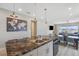 Open-concept kitchen featuring stainless steel appliances, a large island and eat-in dining at 2515 W End Dr, St Cloud, FL 34772