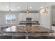 Kitchen island with a granite countertop, stainless steel sink, and pendant lighting at 2515 W End Dr, St Cloud, FL 34772