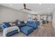 Comfortable open-plan living room with a large blue sectional sofa and stylish decor at 2515 W End Dr, St Cloud, FL 34772