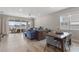 Bright, open-concept living space showcasing a large blue sofa, dining table, and sliding doors leading to the patio at 2515 W End Dr, St Cloud, FL 34772