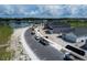 Aerial view of new construction homes in community, showcasing the street and a nearby lake at 2630 Great Heron Ave, St Cloud, FL 34773