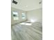 Large bedroom featuring natural light, two windows, and plank flooring at 273 Marion Oaks Golf Rd, Ocala, FL 34473