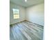 Bedroom showcasing bright natural light, window, and plank flooring at 273 Marion Oaks Golf Rd, Ocala, FL 34473