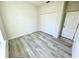 Clean bedroom with hardwood floors, closet doors, and a bright window at 273 Marion Oaks Golf Rd, Ocala, FL 34473
