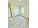 Bedroom featuring natural light, plank flooring, window and closet at 273 Marion Oaks Golf Rd, Ocala, FL 34473