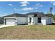 Side view of a modern white home with black trim and a well-manicured lawn at 273 Marion Oaks Golf Rd, Ocala, FL 34473