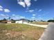 View of a modern white home with black trim and a well-manicured lawn at 273 Marion Oaks Golf Rd, Ocala, FL 34473