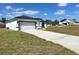 Charming single-story home featuring a two-car garage, white exterior, and black trim at 273 Marion Oaks Golf Rd, Ocala, FL 34473
