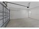 Spacious two-car garage with white brick walls and cement floor at 273 Marion Oaks Golf Rd, Ocala, FL 34473