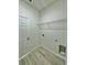 Laundry room featuring new flooring, wire shelving and modern hookups at 273 Marion Oaks Golf Rd, Ocala, FL 34473