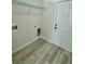 View of new laundry room with gray flooring, shelving and hookups at 273 Marion Oaks Golf Rd, Ocala, FL 34473