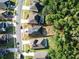 Aerial view of a home with a backyard bordering a wooded area, highlighted with property lines in a residential neighborhood at 34423 Alameda Dr, Sorrento, FL 32776