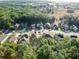 Scenic aerial view of a neighborhood showcasing tree-lined streets and well-maintained homes with lush greenery surroundings at 34423 Alameda Dr, Sorrento, FL 32776