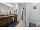 Bathroom featuring a granite countertop vanity with double sinks and tile flooring at 34423 Alameda Dr, Sorrento, FL 32776
