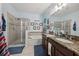 Bathroom featuring double sinks with granite countertops, a soaking tub, and a walk-in shower at 34423 Alameda Dr, Sorrento, FL 32776