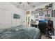 Bedroom featuring a queen bed, a black office chair, and a wall mounted TV at 34423 Alameda Dr, Sorrento, FL 32776