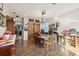 Open dining room with a rustic wood table, barn doors, hardwood floors, and a unique lighting fixture at 34423 Alameda Dr, Sorrento, FL 32776