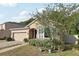 Inviting single-story home featuring a brick driveway, stone accents, manicured landscaping, and a welcoming entrance at 34423 Alameda Dr, Sorrento, FL 32776