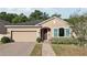Charming single-story home featuring a brick driveway, a welcoming front porch and manicured landscaping at 34423 Alameda Dr, Sorrento, FL 32776