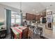 Open concept kitchen with granite counters, stainless appliances, and adjacent dining area with bar stool seating at 34423 Alameda Dr, Sorrento, FL 32776