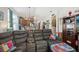 Open-concept living room and kitchen with a sectional sofa and access to the backyard at 34423 Alameda Dr, Sorrento, FL 32776