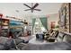 Comfortable living room featuring a large screen TV, sectional sofa, and a door leading to the backyard at 34423 Alameda Dr, Sorrento, FL 32776