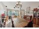 Bright and airy living room showcasing hardwood floors, a rustic dining table, and a large window at 34423 Alameda Dr, Sorrento, FL 32776