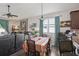 Comfortable living space with adjacent dining area featuring modern furniture and lots of natural light at 34423 Alameda Dr, Sorrento, FL 32776