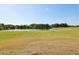 Scenic community pond surrounded by green fairways under a sunny sky, offering serene views and outdoor enjoyment at 34423 Alameda Dr, Sorrento, FL 32776