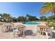 Pool area with tables and chairs, providing a perfect space for relaxation and socializing by the pool at 34423 Alameda Dr, Sorrento, FL 32776