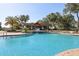 The community pool is surrounded by lush landscaping and includes a water feature, and a covered picnic area at 34423 Alameda Dr, Sorrento, FL 32776
