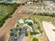 An aerial view of the community's pool, clubhouse, parking, and walking paths at 3661 Kingswood Ct, Clermont, FL 34711