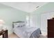 Bedroom with light green walls, double closets, and comfortable furnishings at 3661 Kingswood Ct, Clermont, FL 34711