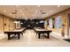 Upscale billiard room with multiple tables, custom lighting, and ample seating at 3661 Kingswood Ct, Clermont, FL 34711