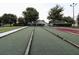 Beautiful bocce ball court with seating areas and walking path for enjoyable outdoor activities at 3661 Kingswood Ct, Clermont, FL 34711
