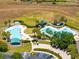 The community pool features a splash pad, covered areas, and plenty of lounge chairs at 3661 Kingswood Ct, Clermont, FL 34711